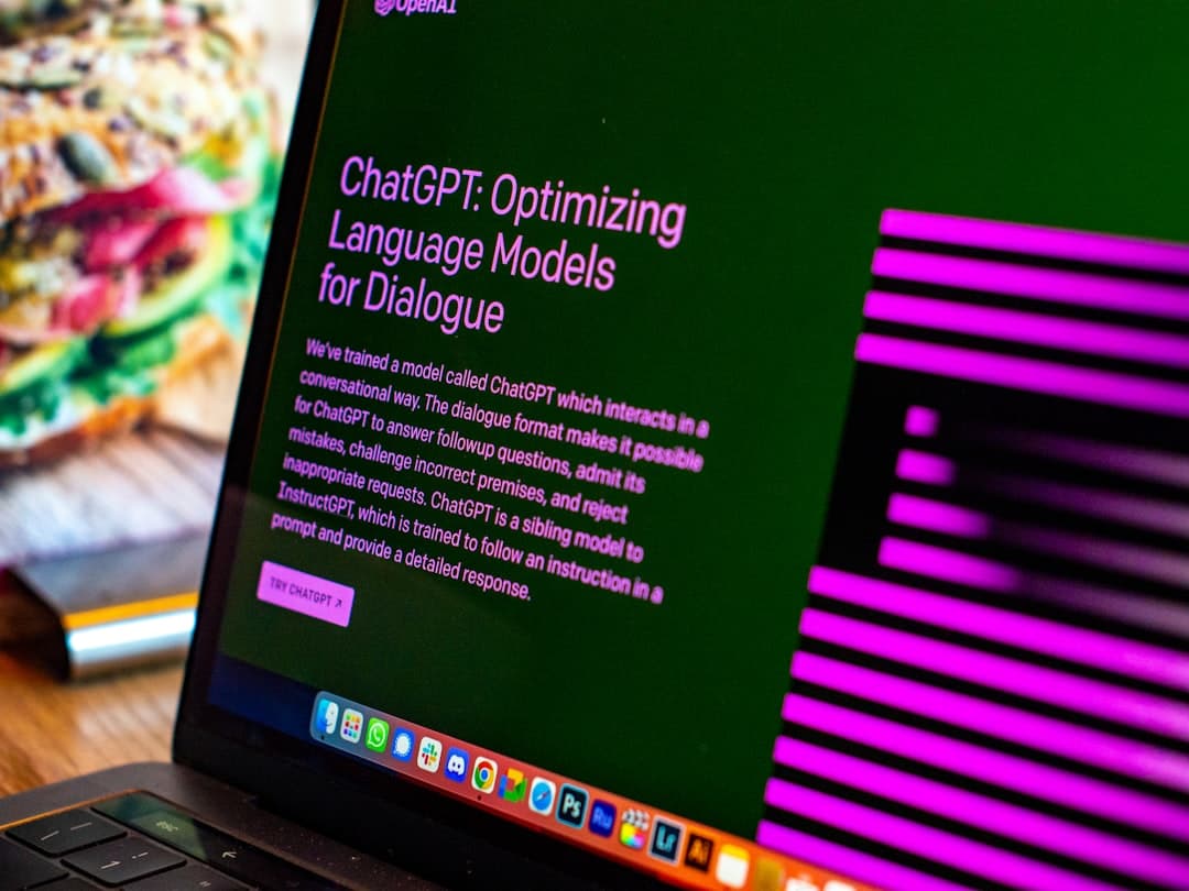 Laptop on wooden desk, generating dynamic OG images via API for Compet author content.